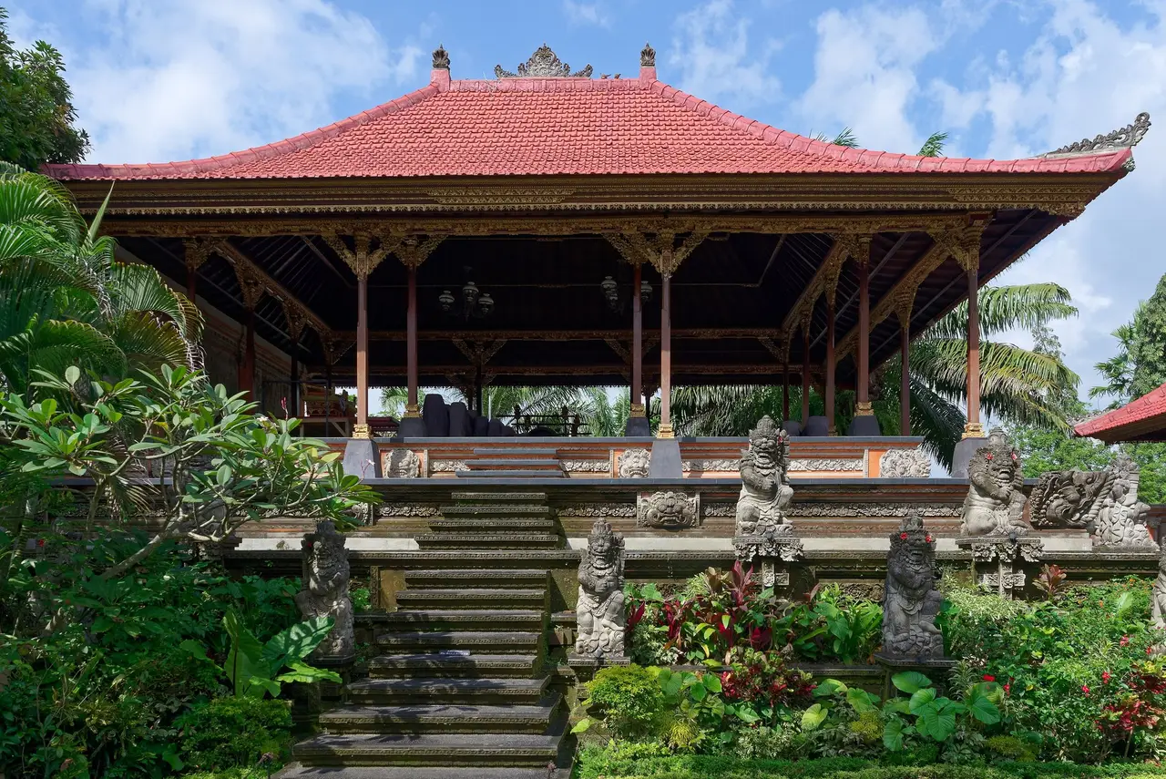 A pavilion of Puri Saren Agung, Ubud’s royal palace, its red tiled roof and stone statues