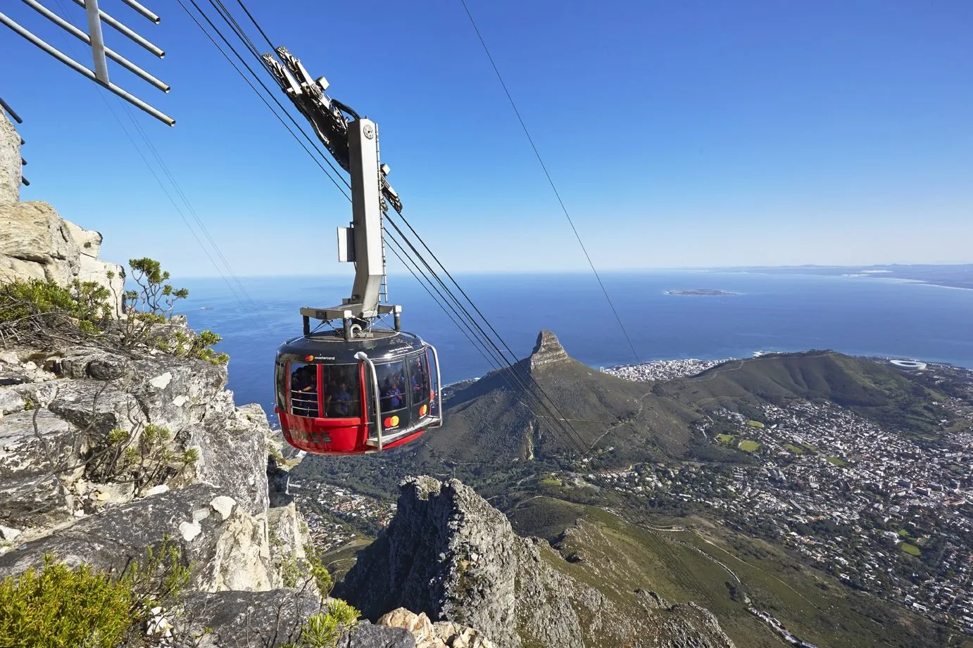 The Table Mountain cable car above Lion’s Head and the sea