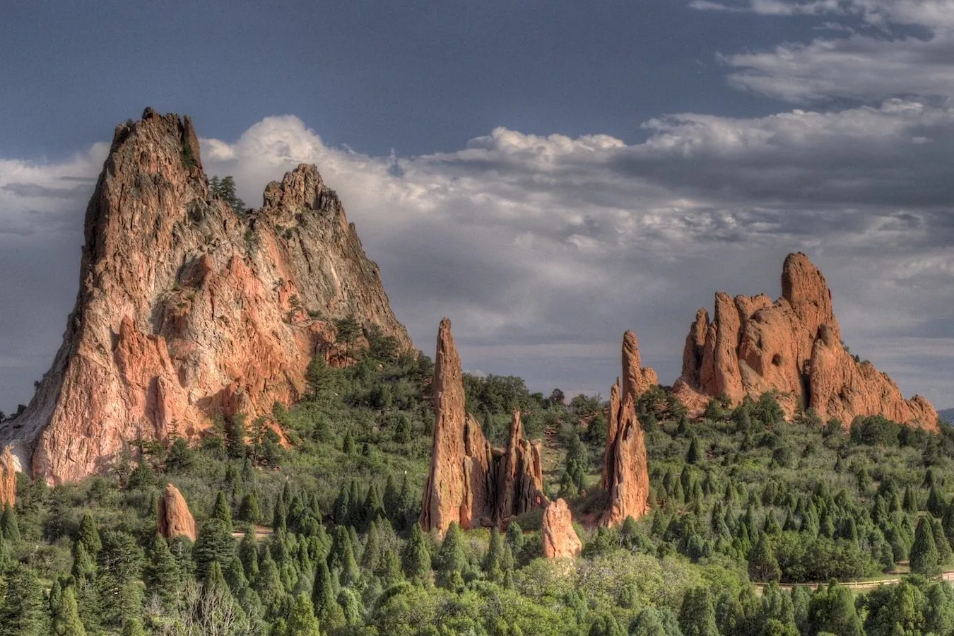 The red sandstone rocks of the Garden of the Gods over a pine wood