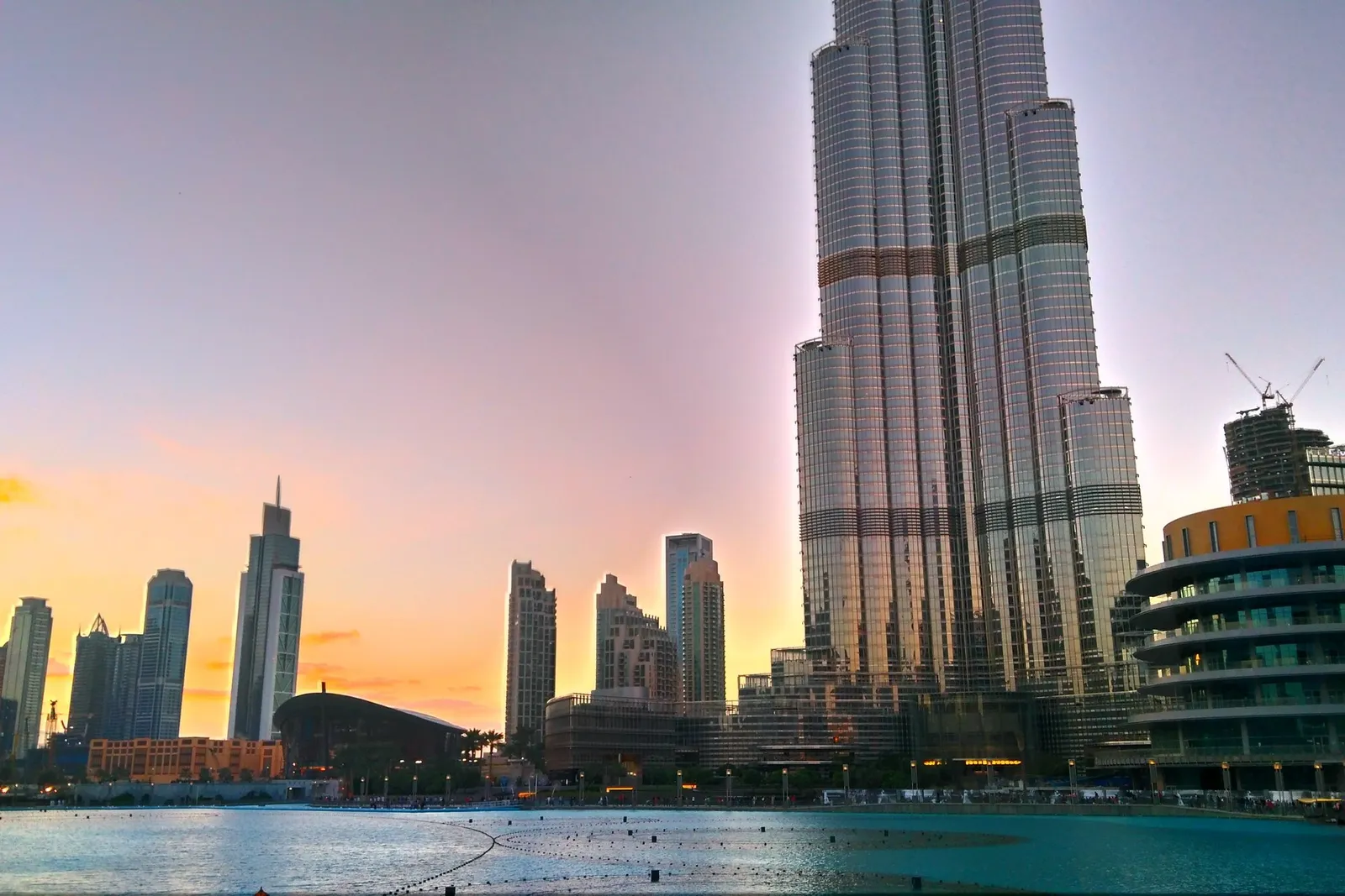 The Burj Khalifa above the fountain lake at sunset