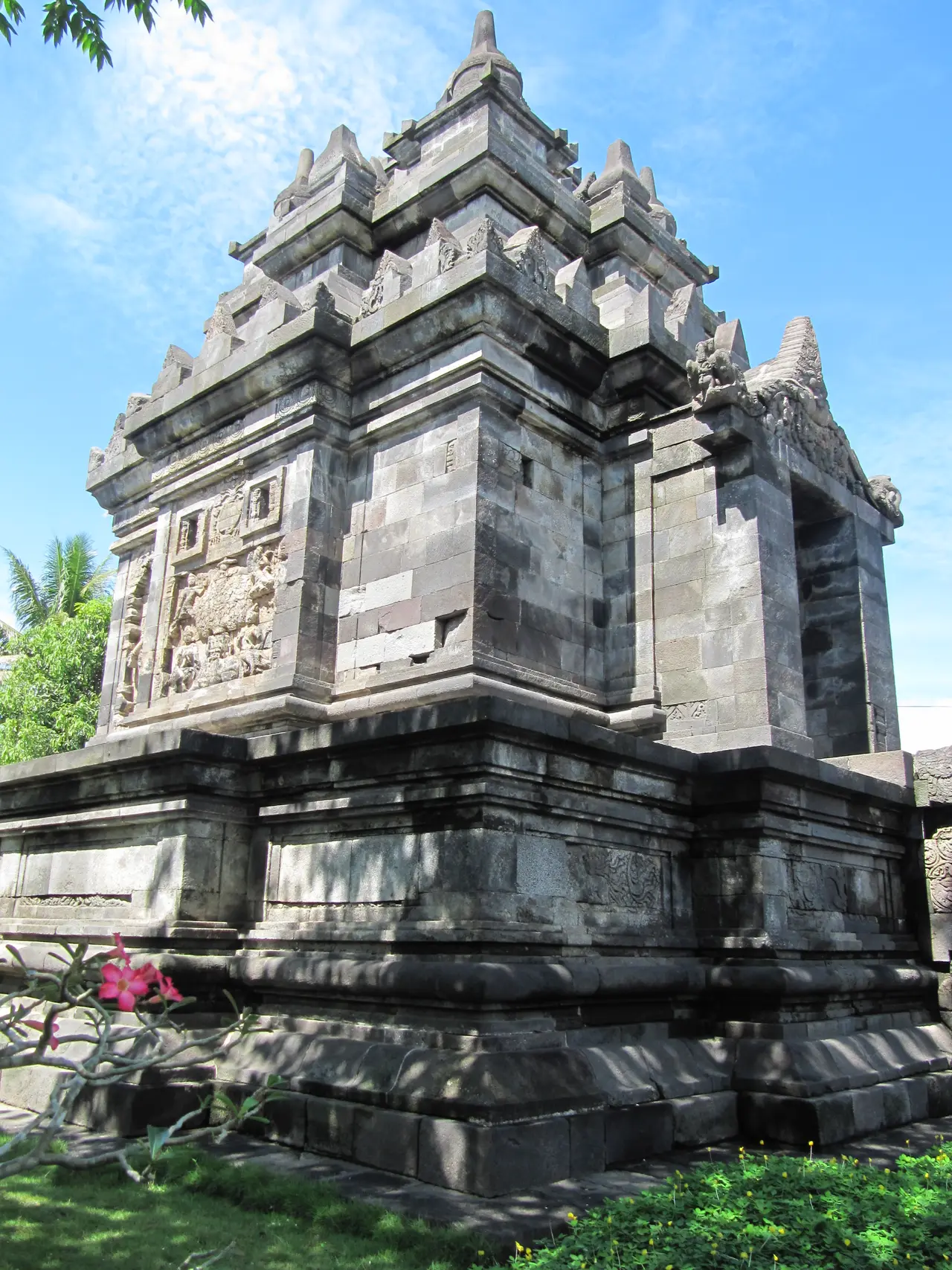 The small stone temple of Pawon under a blue sky