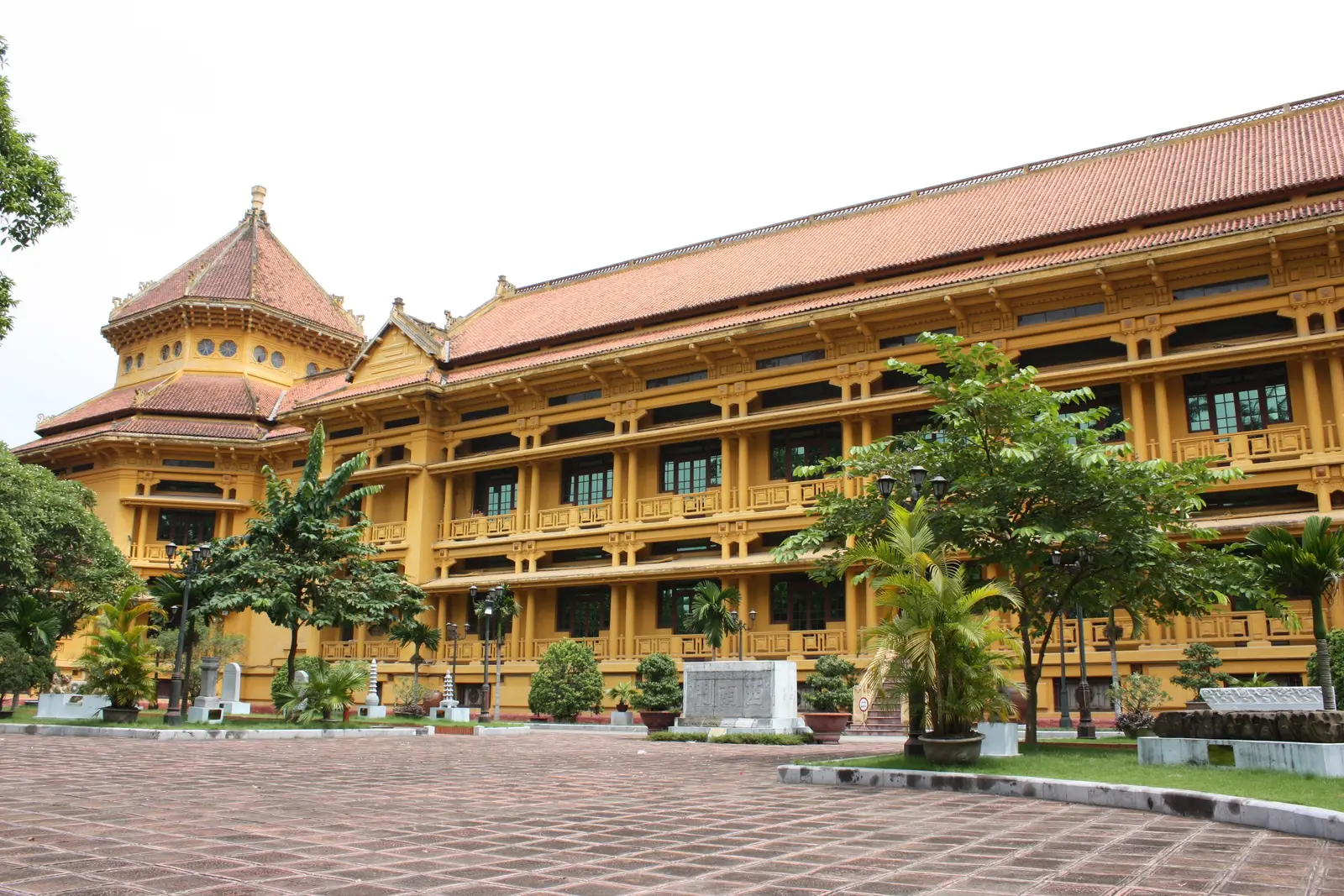 The Vietnam National Museum of History: a yellow building with tiled roofs and an octagonal tower