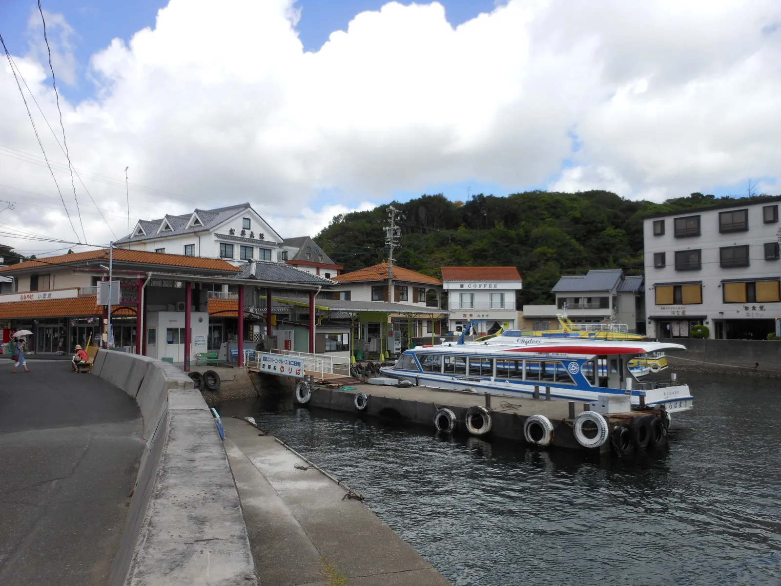 Kashikojima’s small harbour, a white excursion boat moored at the quay