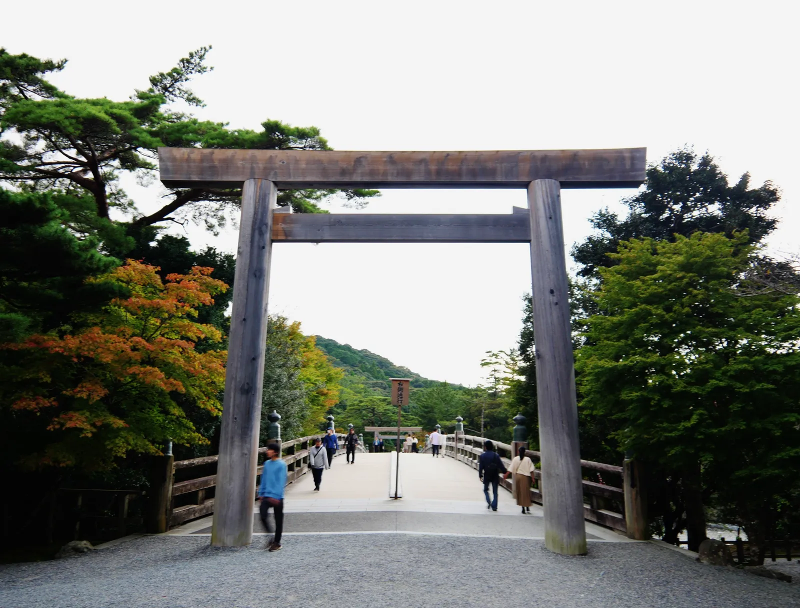 The Uji Bridge at Ise’s inner shrine, a large wooden torii at its end, trees on either side