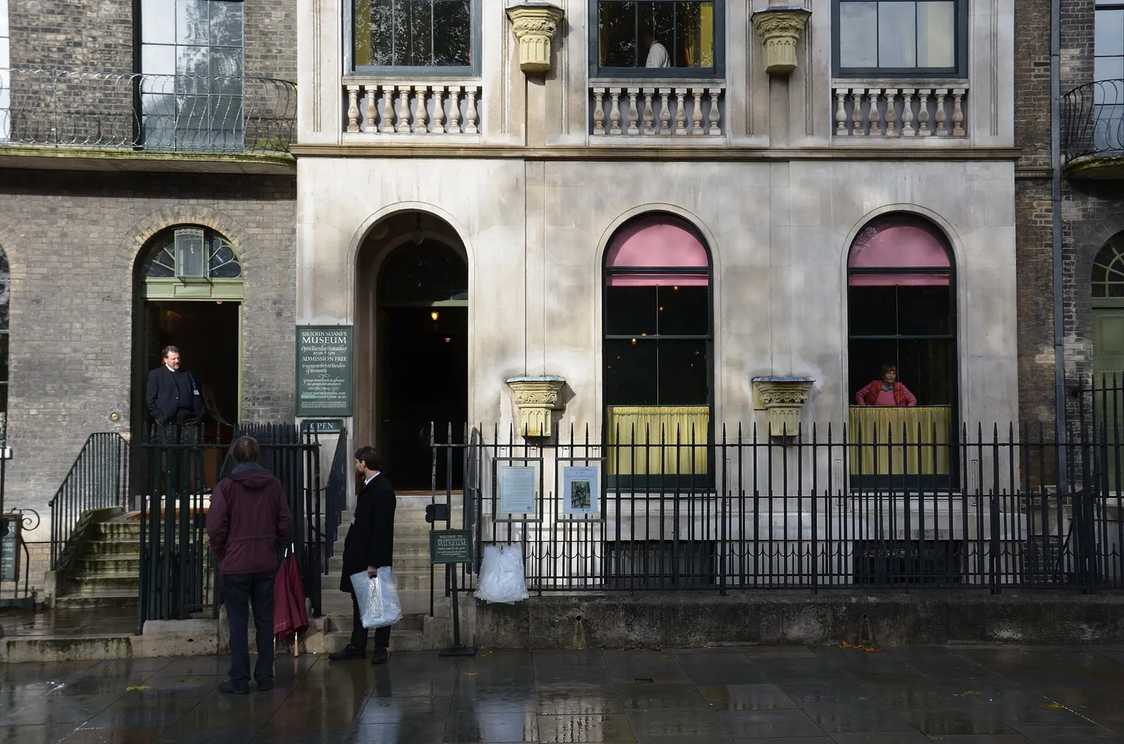 The entrance to Sir John Soane’s Museum on Lincoln’s Inn Fields, with its black railings and visitors in the rain