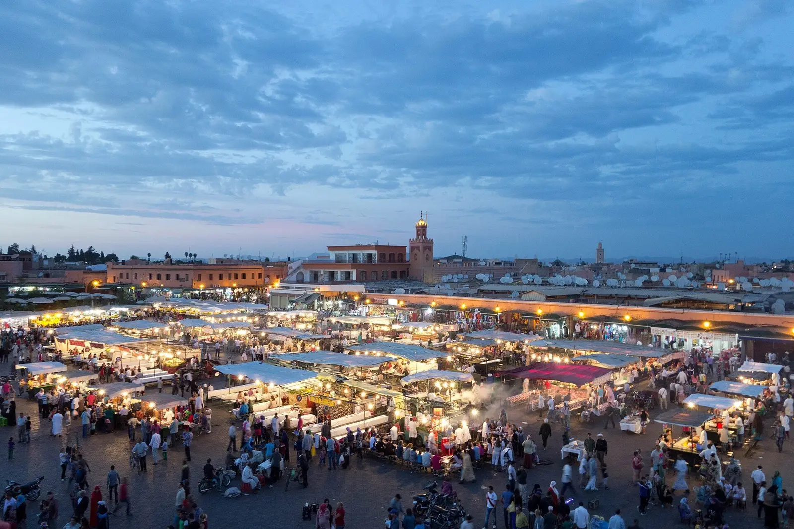 Jemaa el-Fna’s food stalls lit at dusk