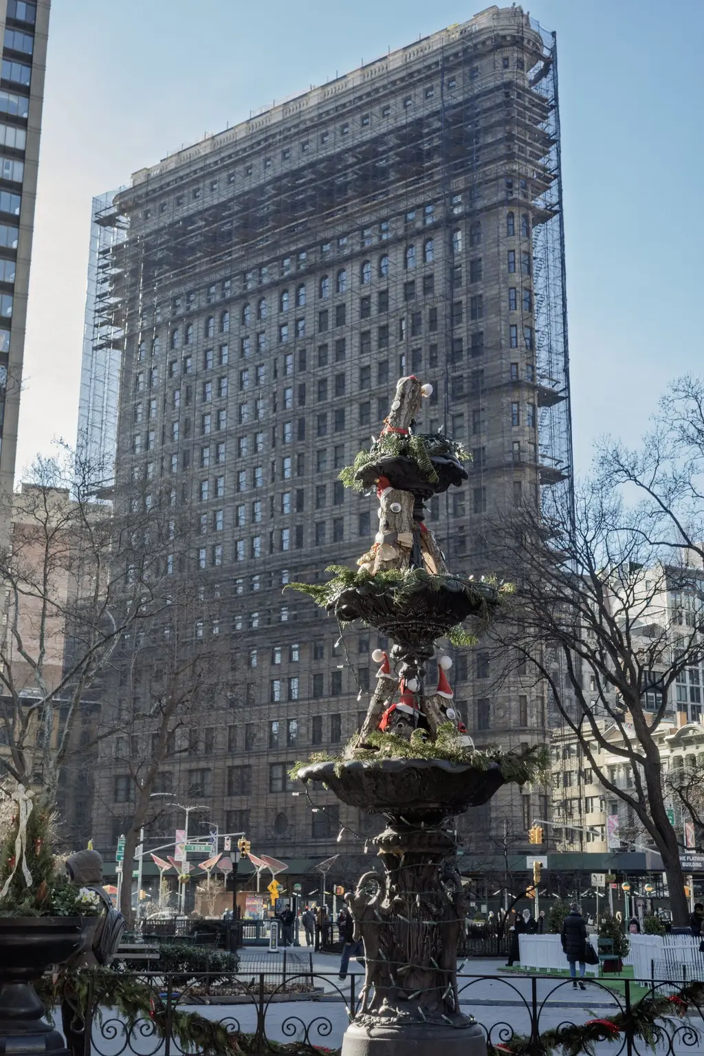 The Madison Square Park fountain among the flowers, the Flatiron behind