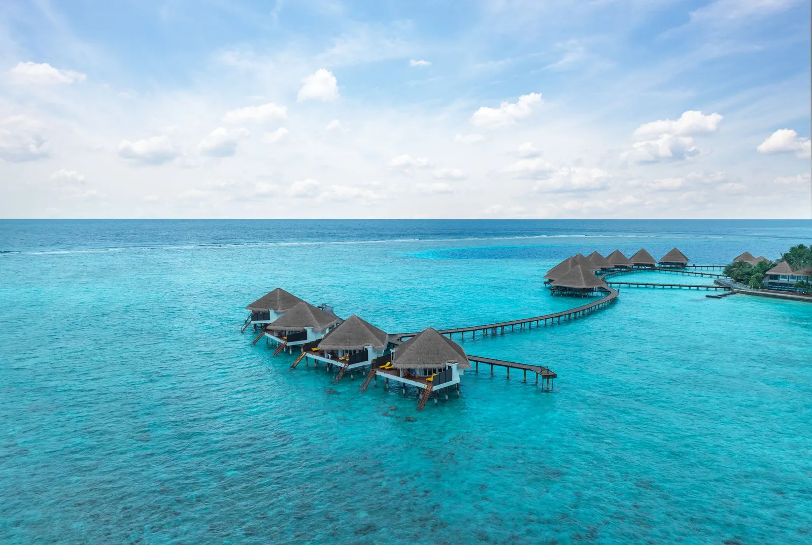 The water villas from above, in a row along the jetty over the lagoon