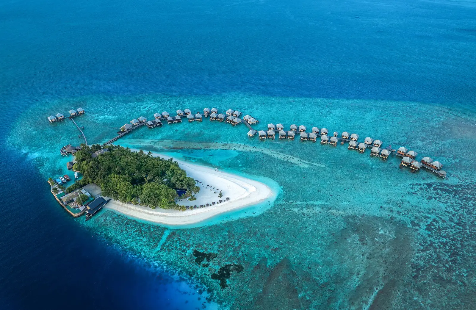 The island and its 2 rows of water villas from above, in the lagoon