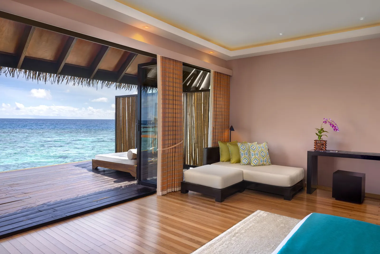 The Overwater Villa bedroom, open to the deck and the sea
