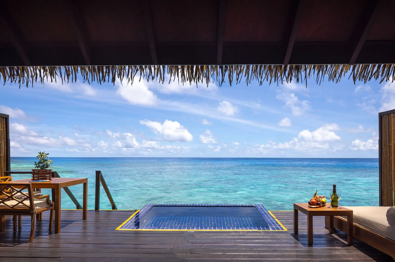 A Sunrise Water Villa deck: the plunge pool and a table facing the sea