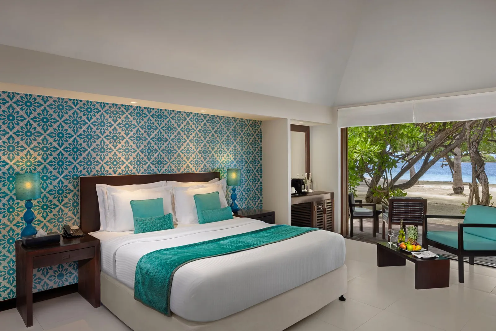A Deluxe Beach Villa: the turquoise patterned wall and the beach beyond the doors