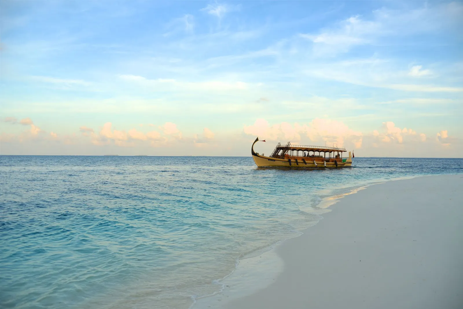 A dhoni in the lagoon off the beach