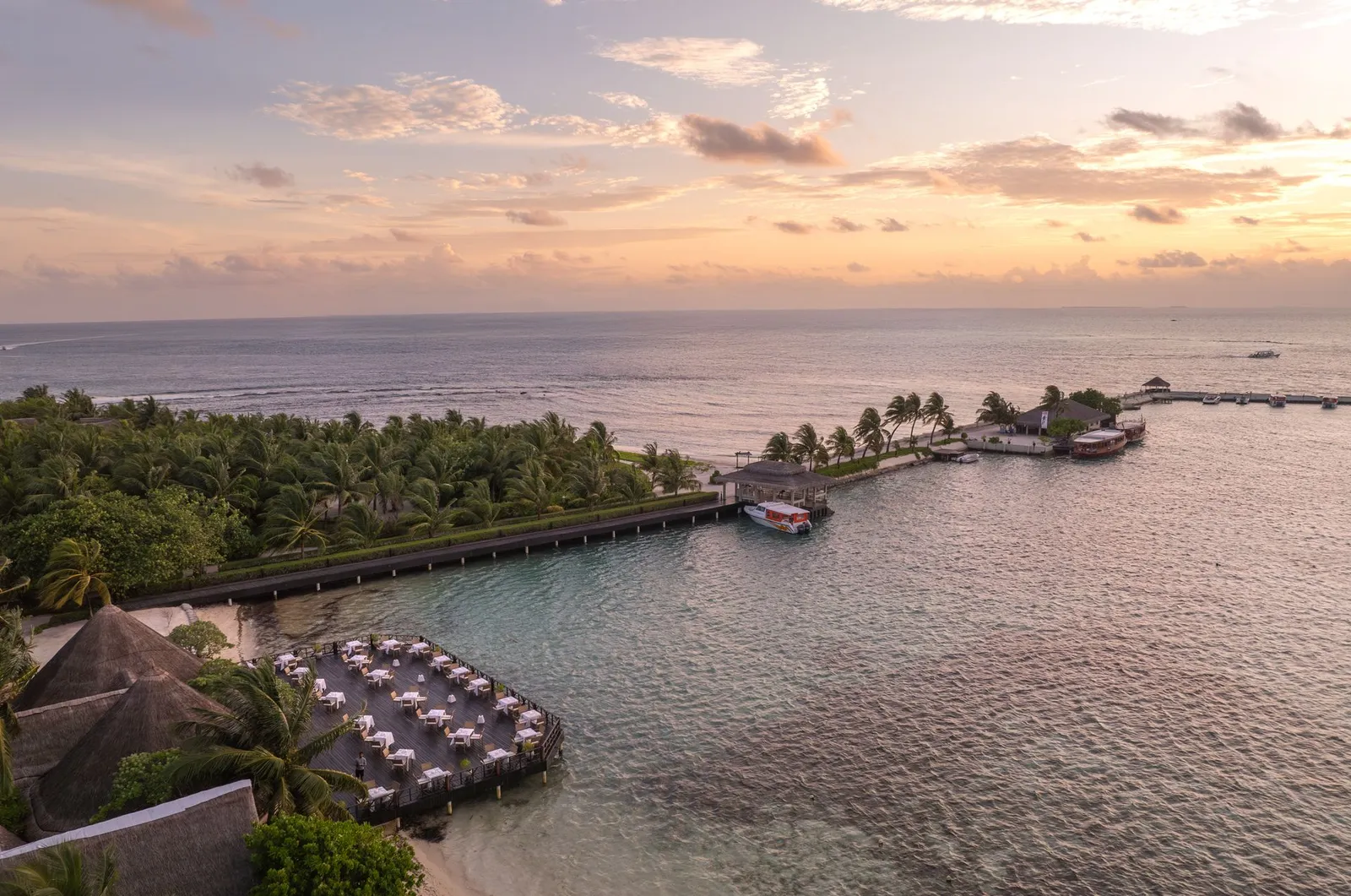 The Sunset Restaurant from the air, over the water by the harbour, at sunset
