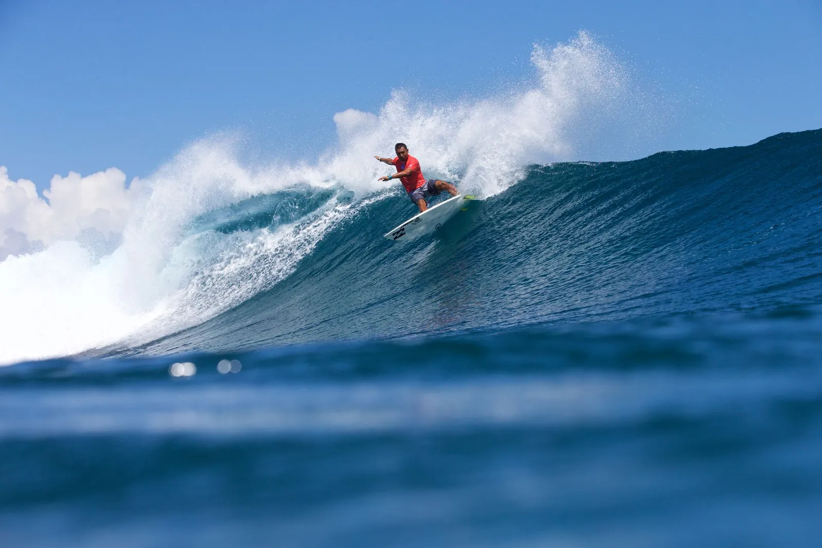 A surfer on the face of a wave