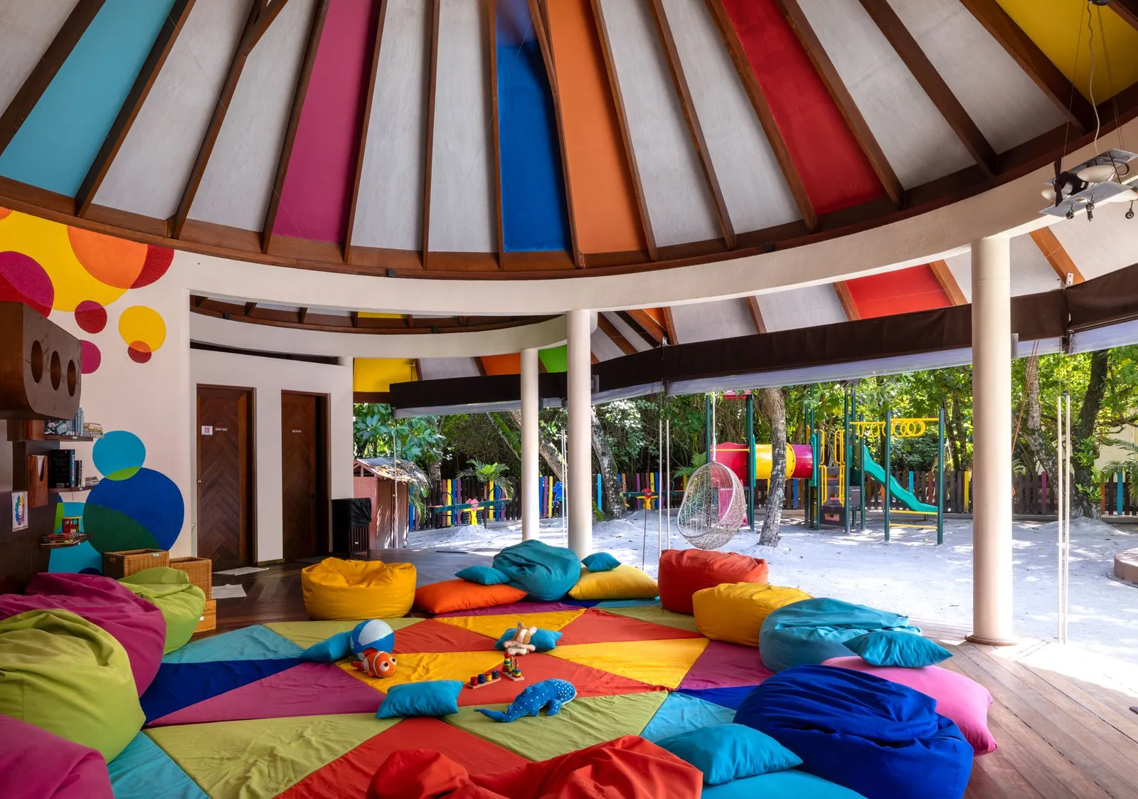 The kids’ club: a bright room with beanbags and the play area outside