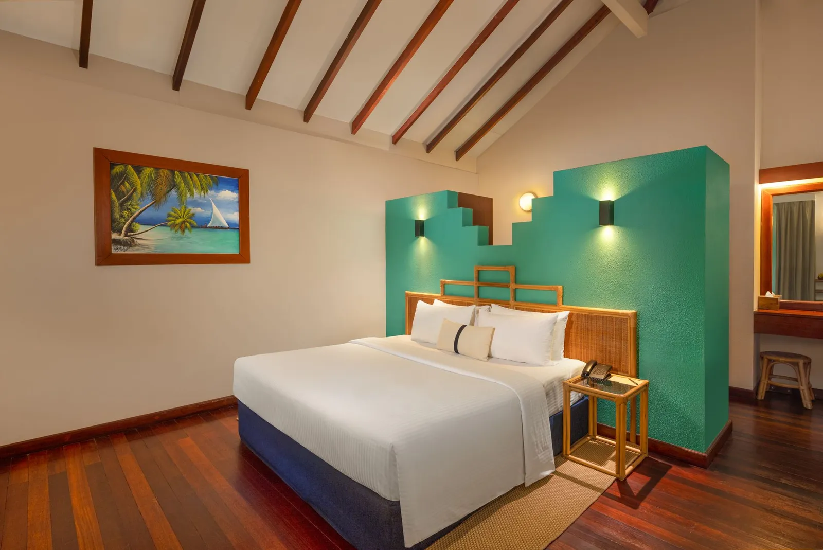 The Honeymoon Suite bedroom, the bed against a turquoise wall