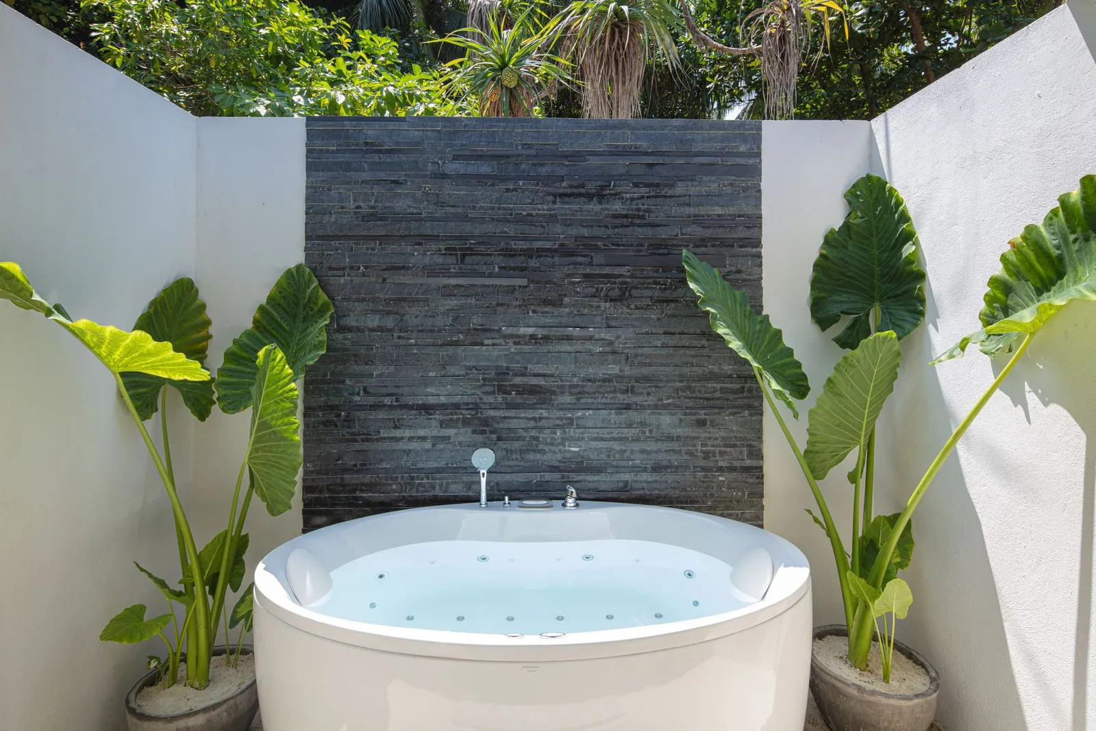 The open-air Jacuzzi of a Jacuzzi Beach Villa, among the plants