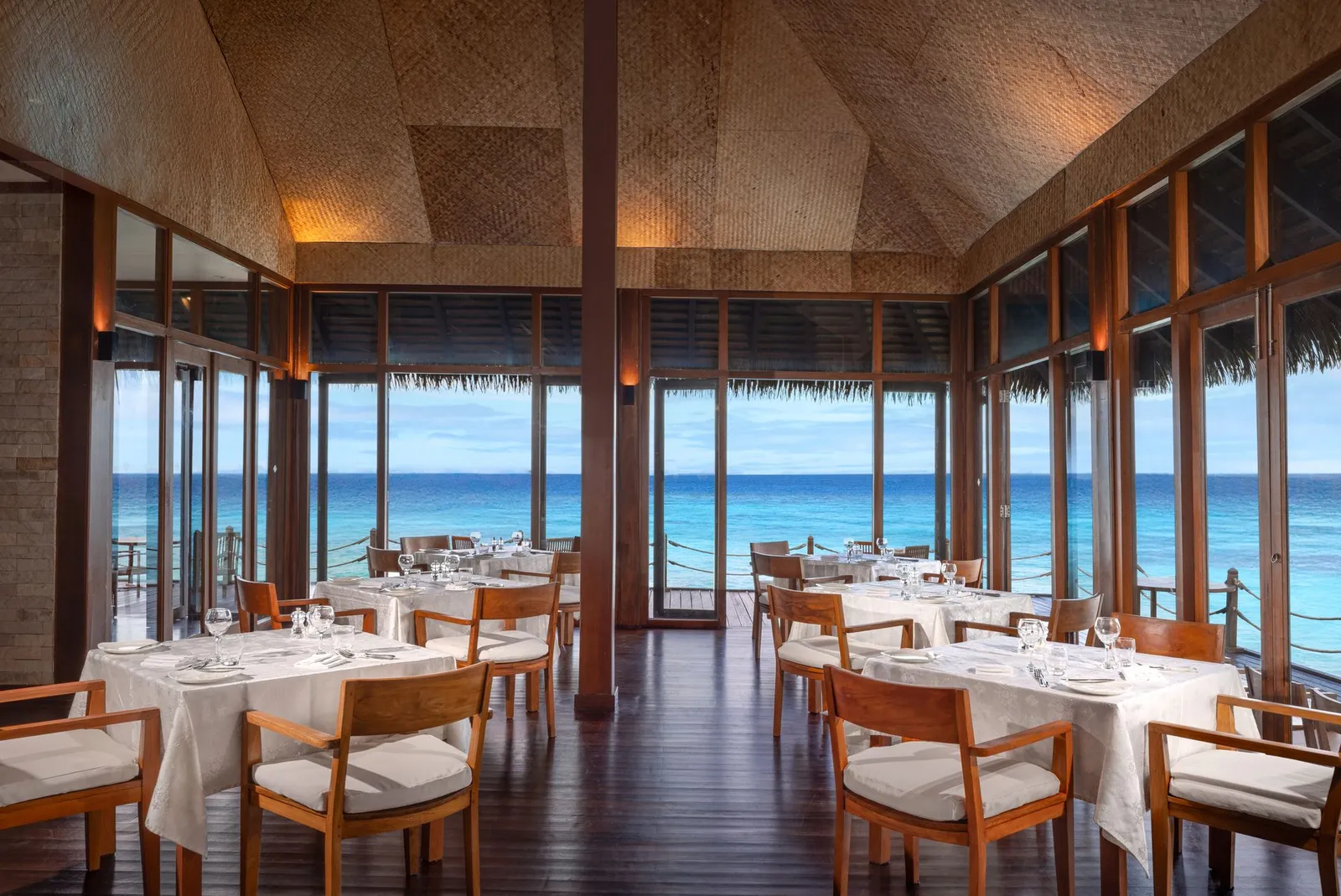 The Water Villa Restaurant: the tables laid and the windows onto the sea