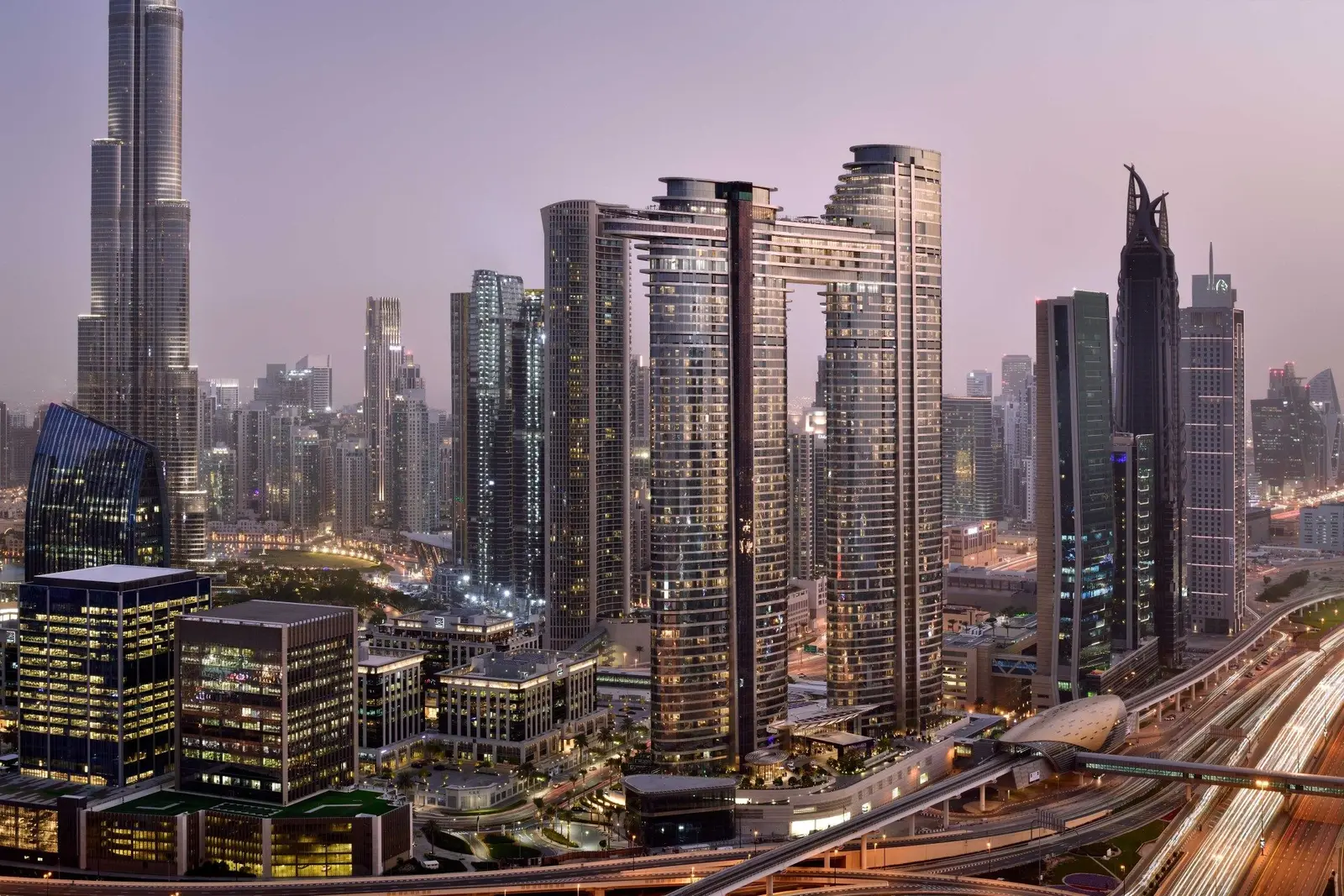 The 2 towers joined by the sky bridge among Downtown’s skyscrapers, at sunset