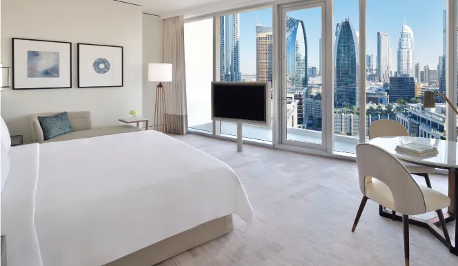 A Club room with a king bed and towers behind the glass