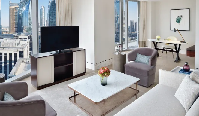 The Panoramic Suite sitting room with armchairs and towers beyond the windows