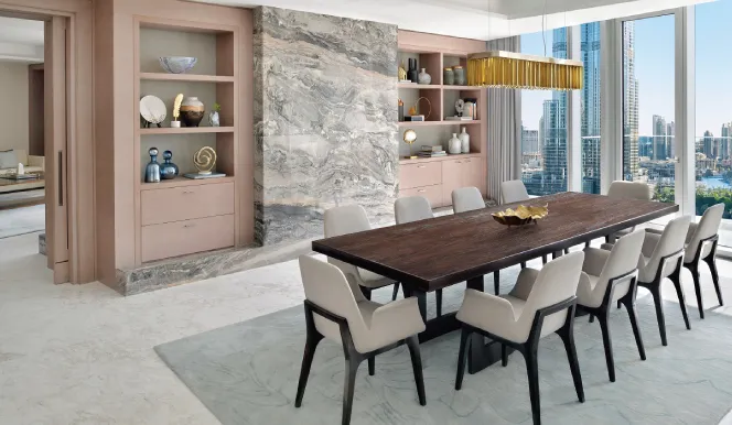 The Presidential Suite dining room with its long table and marble wall