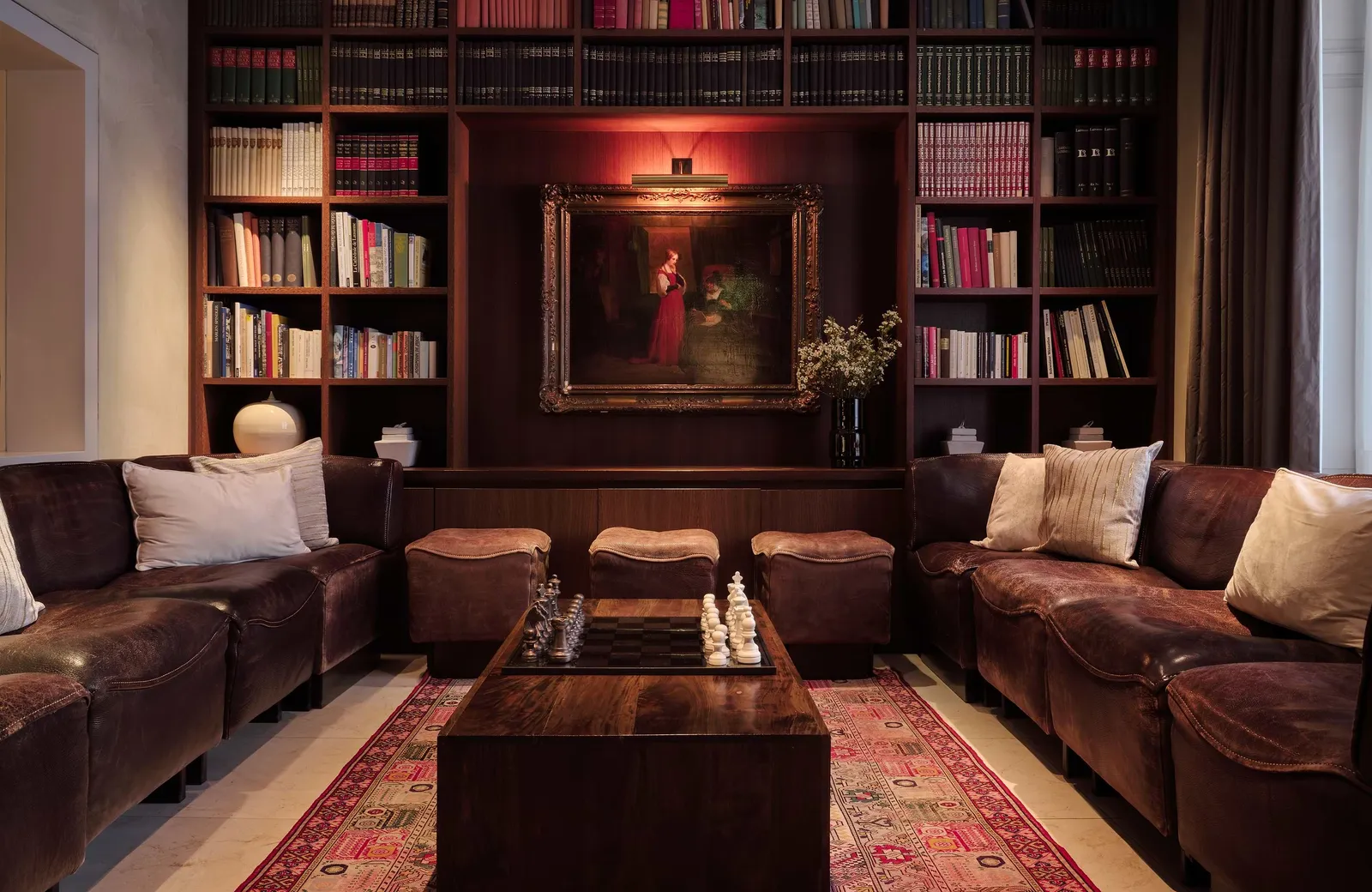 The library with bookshelves, sofas and chessboard