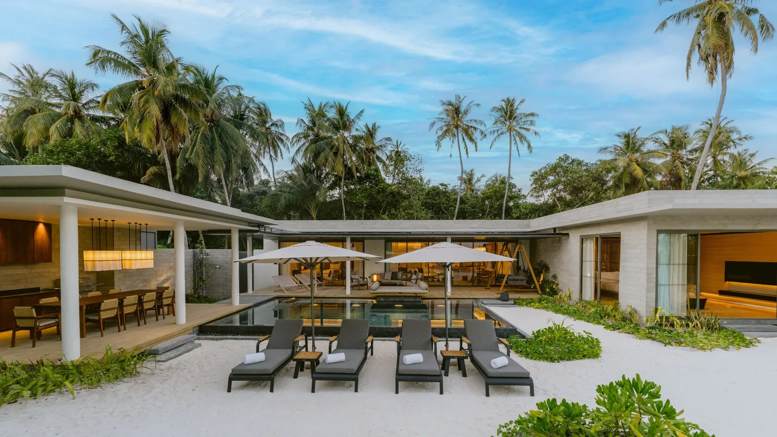 Boduge Residence around its pool, with a covered dining area and loungers.