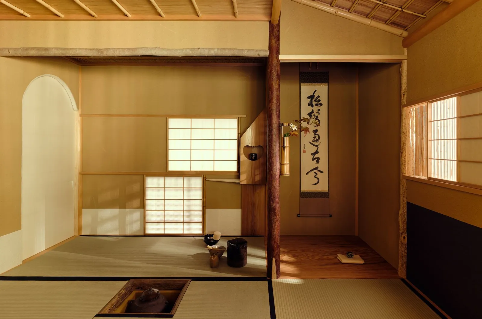 The tea house’s tatami room: paper windows, the calligraphy scroll in the alcove and the kettle in the hearth.
