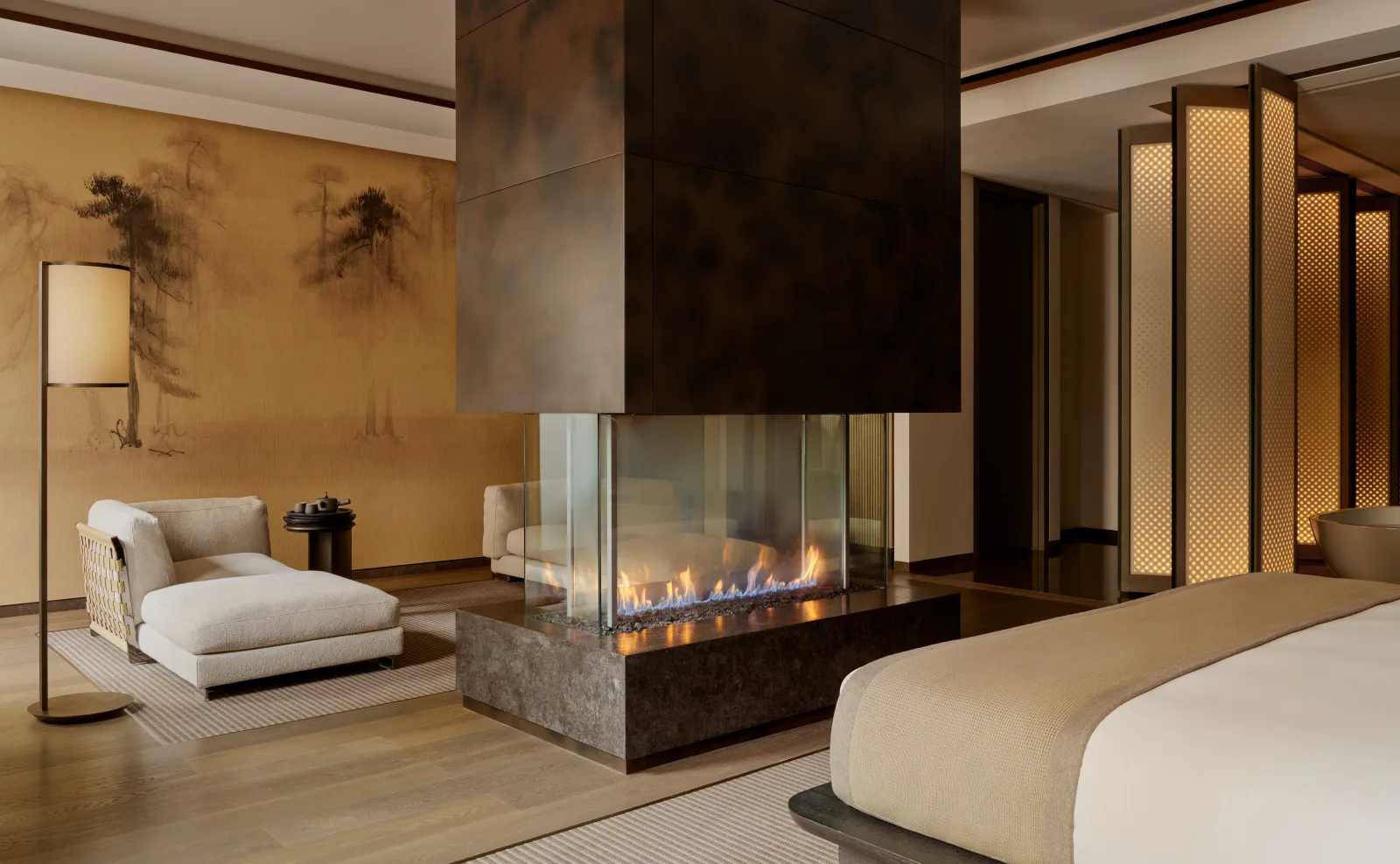 Grand Suite at Aman New York with fireplace, seating area, and neutral tones.