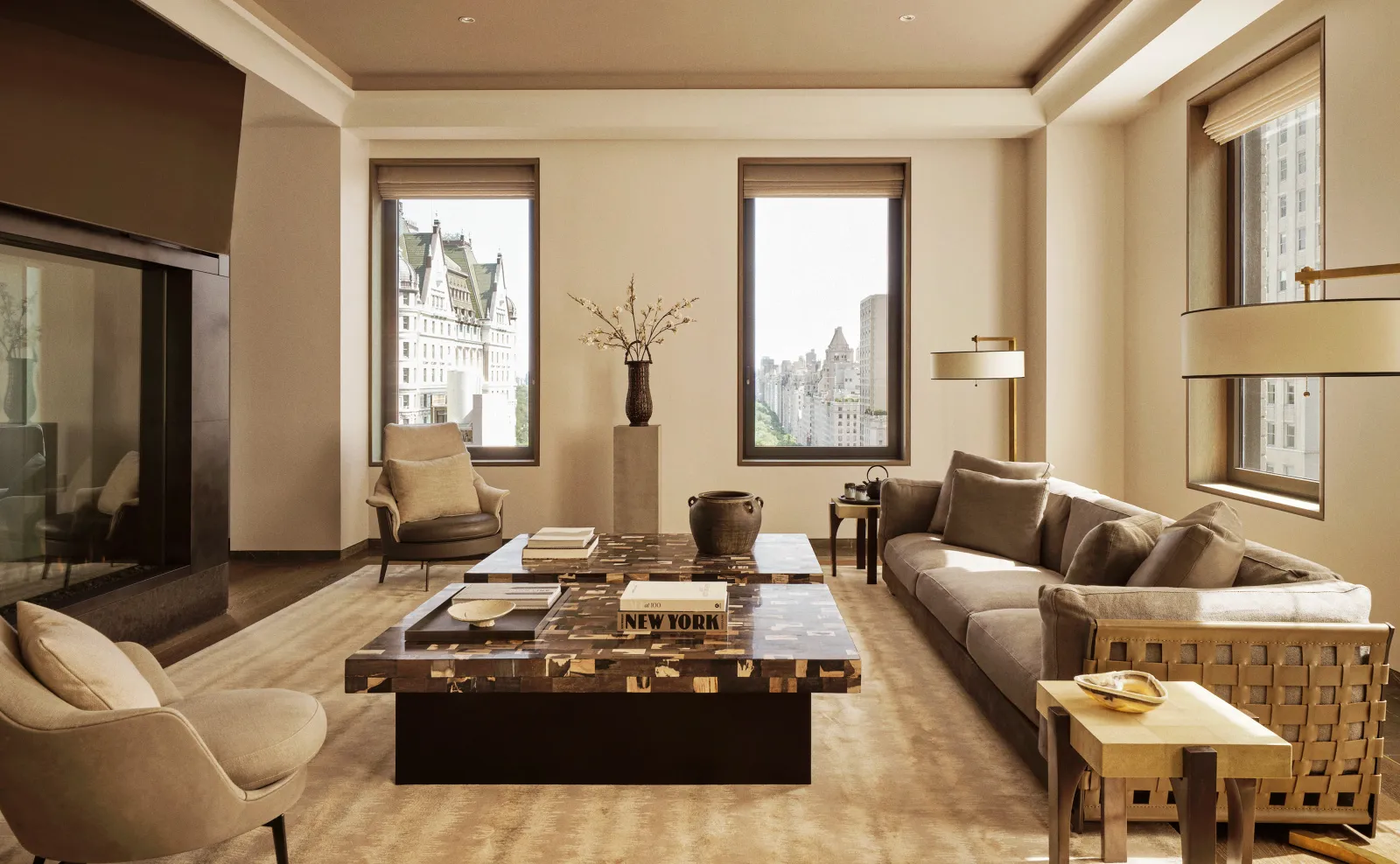 Living area of a 3-bedroom home at Aman New York, featuring neutral tones, large windows, and contemporary furnishings.
