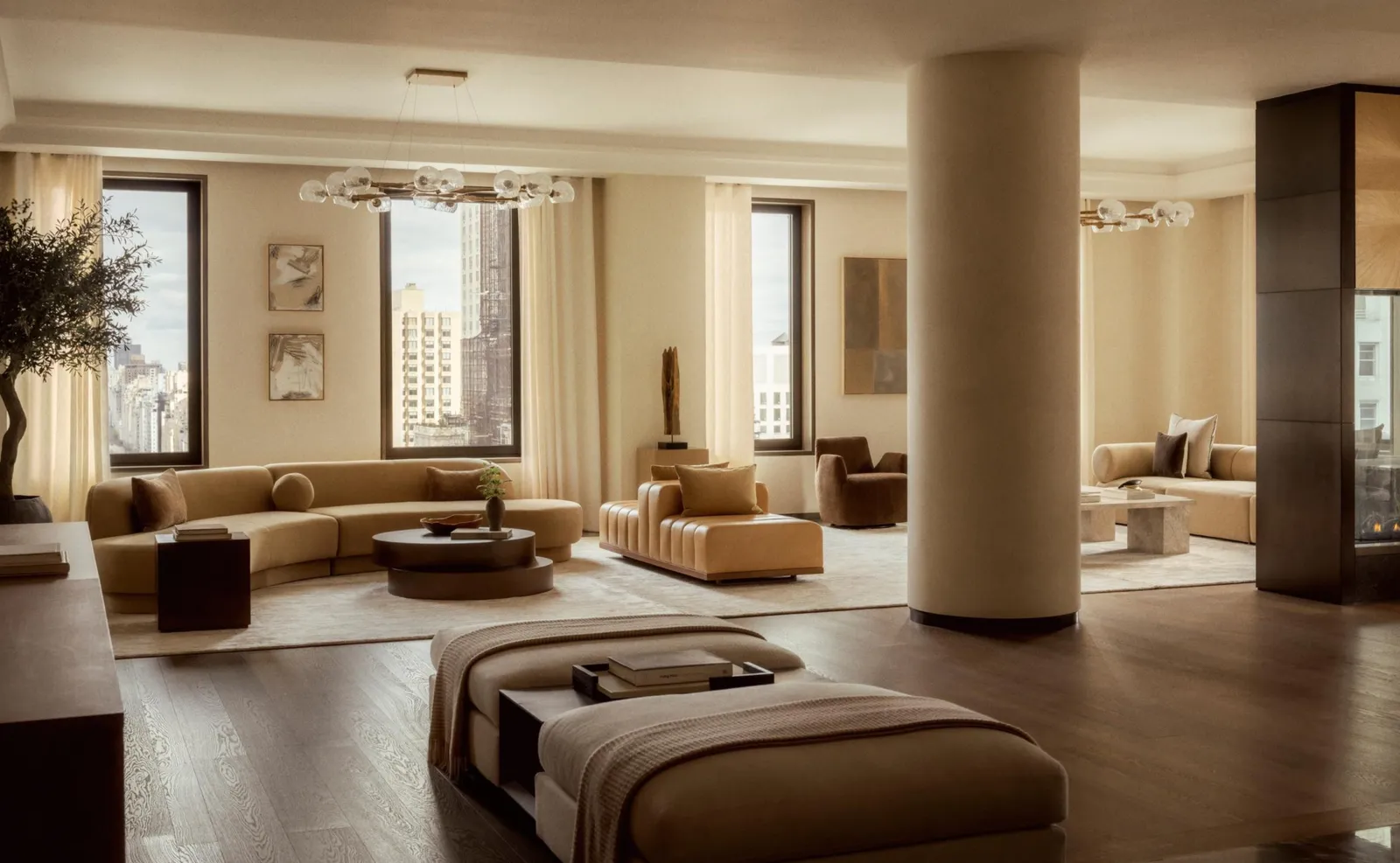 Penthouse living area at Aman New York featuring floor-to-ceiling windows, neutral tones, and contemporary furnishings.