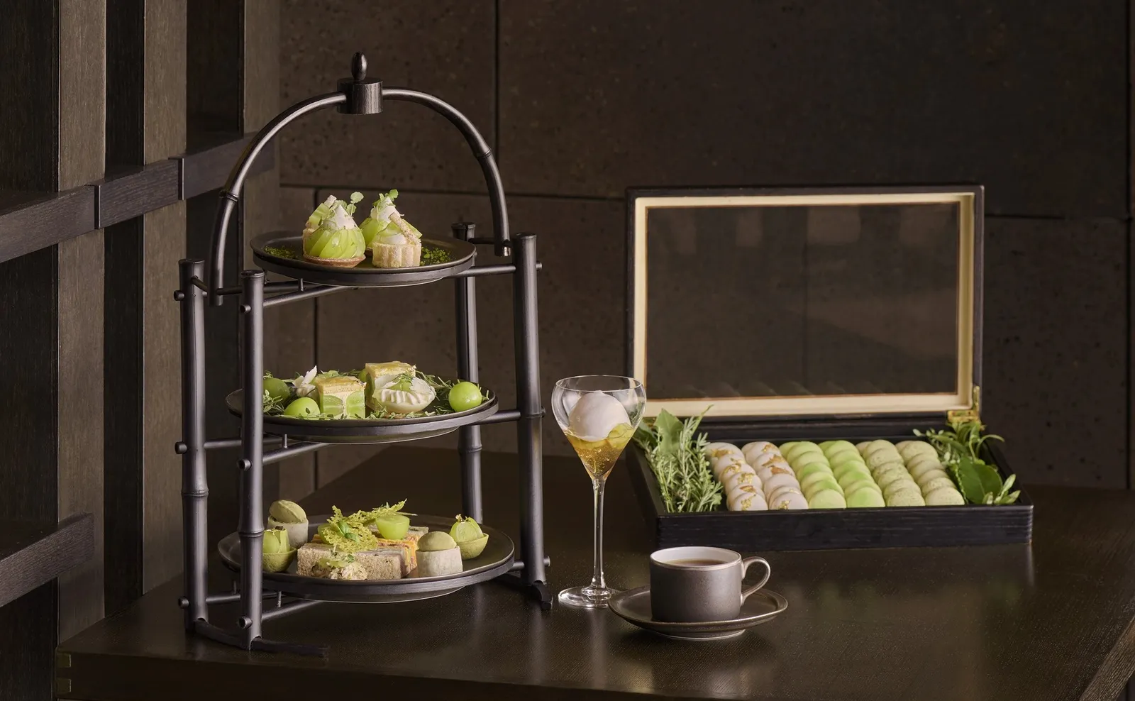 The Shine Muscat afternoon tea: the 3-tier stand, macarons in a box and a glass of sparkling wine.