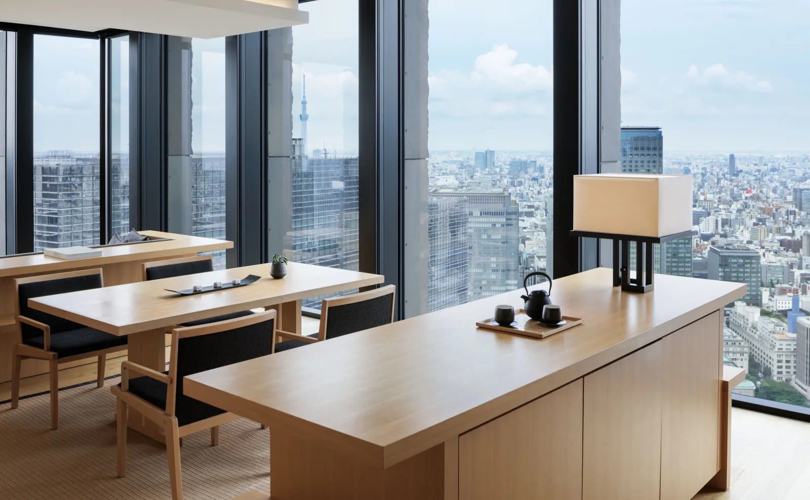 A City Suite’s dining area, with its wooden table and windows on 2 sides onto the city.
