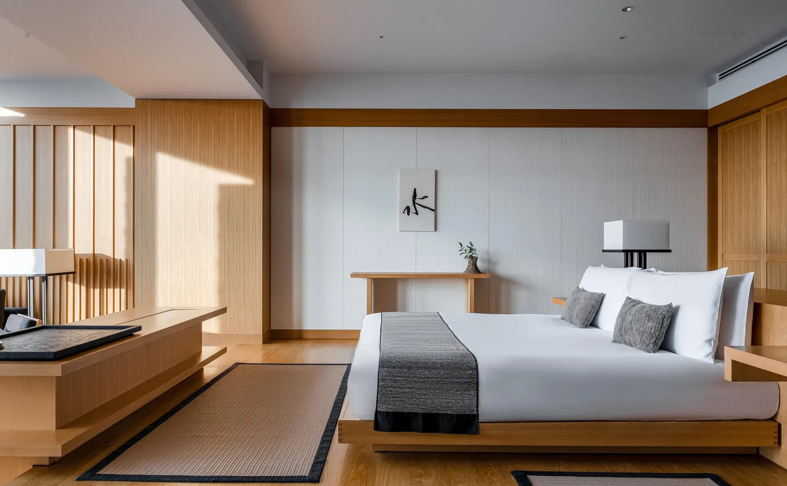 A Deluxe Suite: the low pale-wood bed, the tatami floor and the bench under the window.
