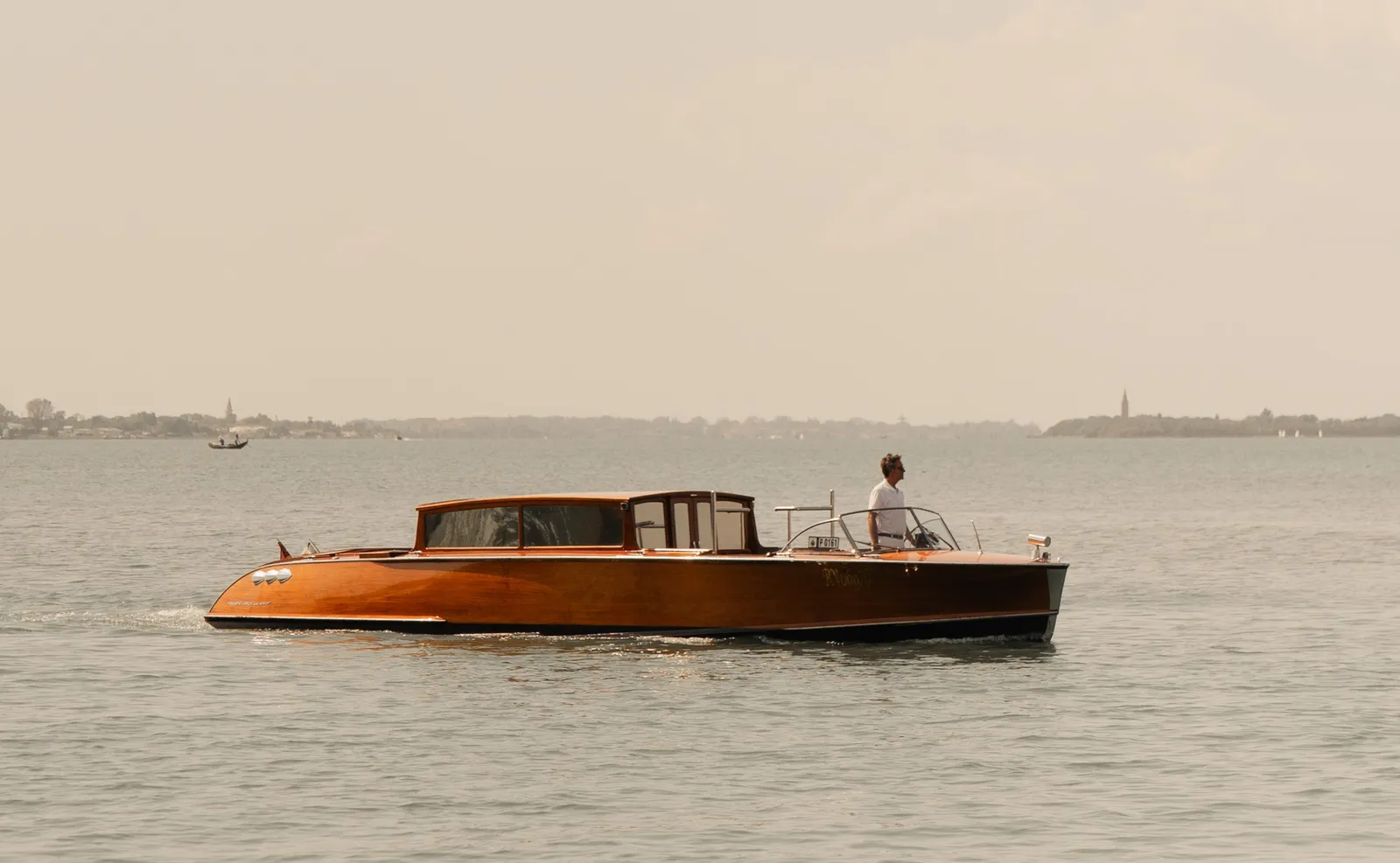 One of the hotel’s timber motorboats crossing the lagoon, a driver at the helm and the islands on the horizon.