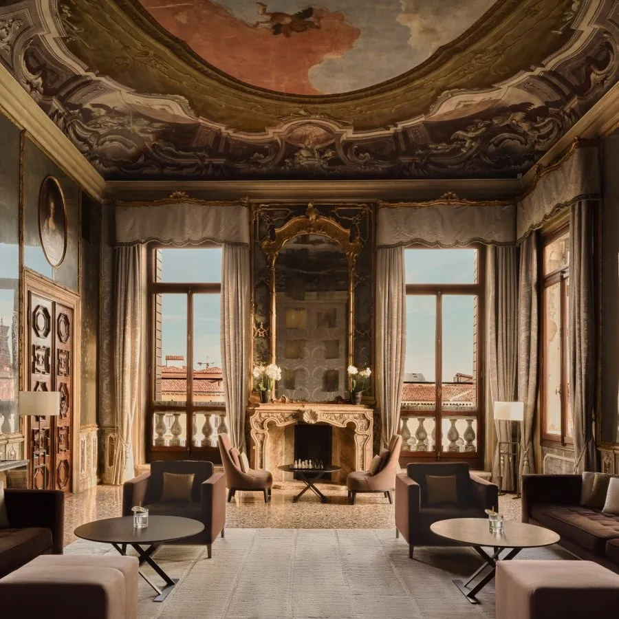 The Tiepolo Room: the frescoed ceiling, the marble fireplace with its mirror and the windows onto the Grand Canal.