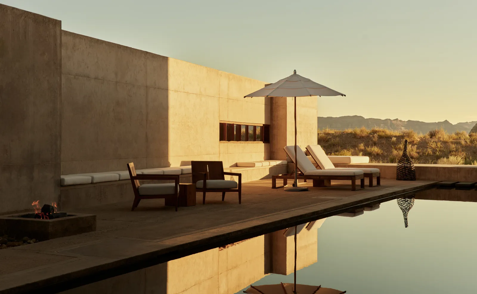 The Amangiri Suite’s terrace at sunset: the parasol, the loungers and the long pool reflecting the wall.