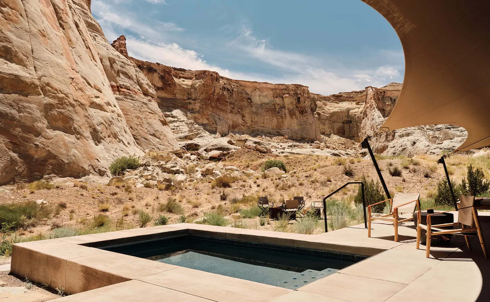 The canyon pavilion’s pool: a square basin on the terrace, under the edge of the canvas, between rock walls.