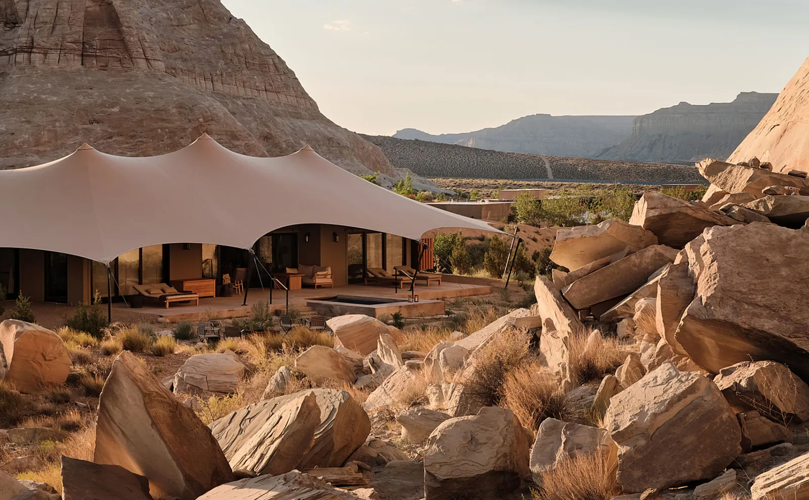 A 2-bedroom pavilion: canvas stretched like a sail above the glass walls, among red sandstone boulders.