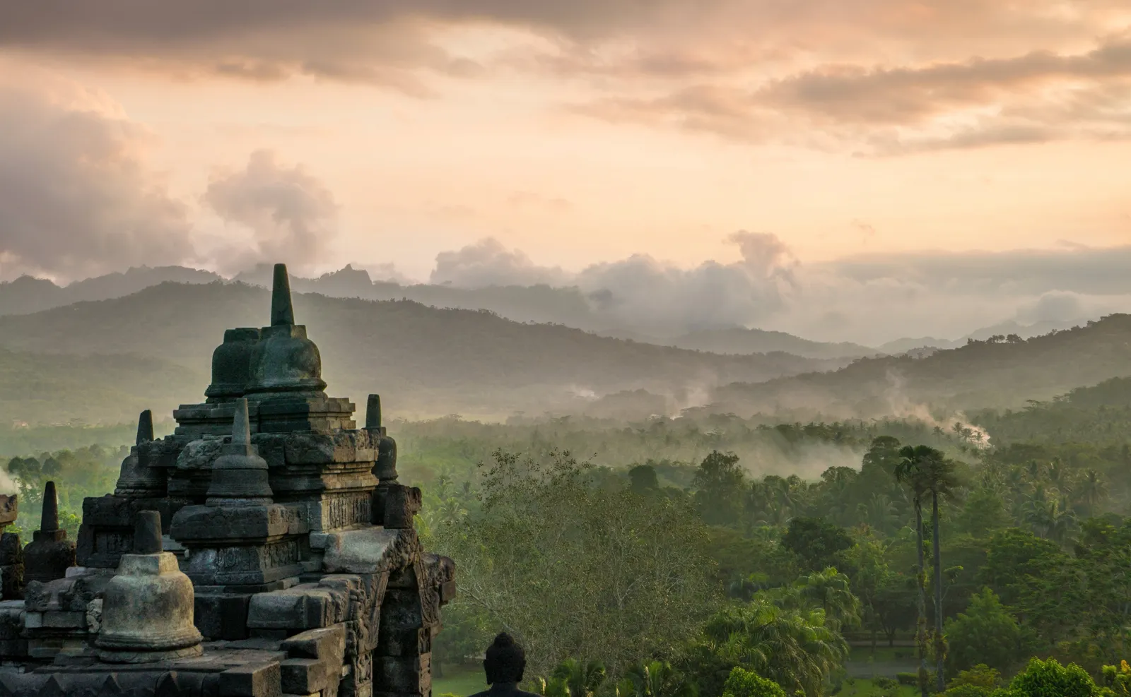 A stupa of Borobudur at dawn above the mist of the Kedu valley