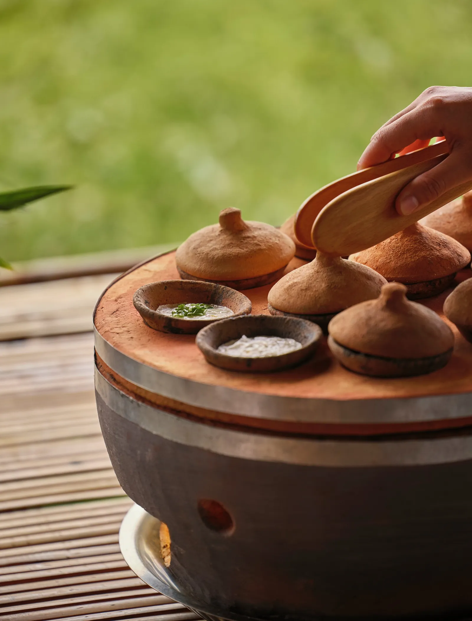 The Vietnamese afternoon tea: bánh căn cooked in little clay pots, with the sauces on the side