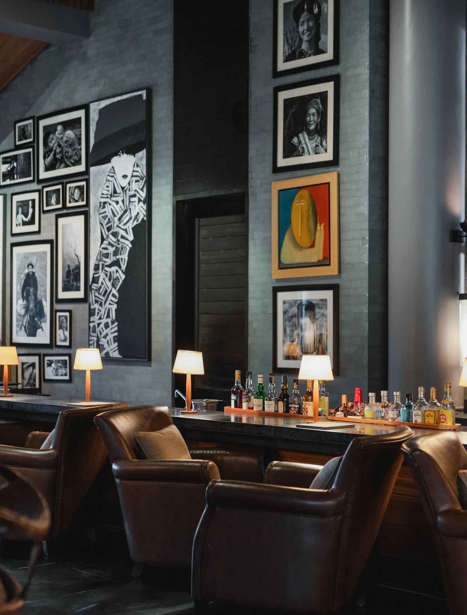 The Bar: leather armchairs, the lit counter and black-and-white photographs on the walls