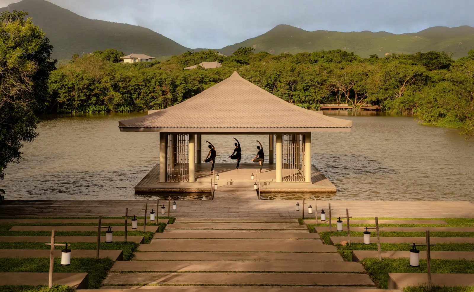 The yoga pavilion on the lotus lake at sunset, at the foot of the lantern-lit steps