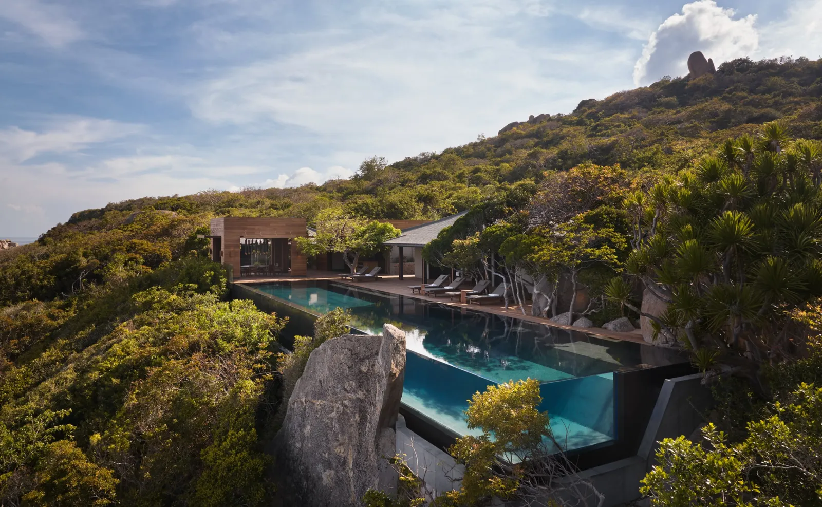 The Amanoi Ocean Pool Residence from above: the main pool held among the boulders over the sea