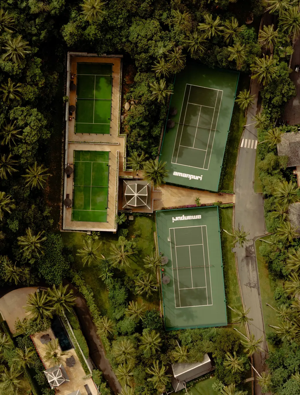The tennis and padel courts from above, among the trees