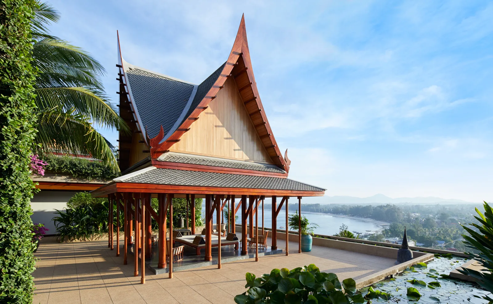 A villa pavilion and pool on a terrace, the sea beyond