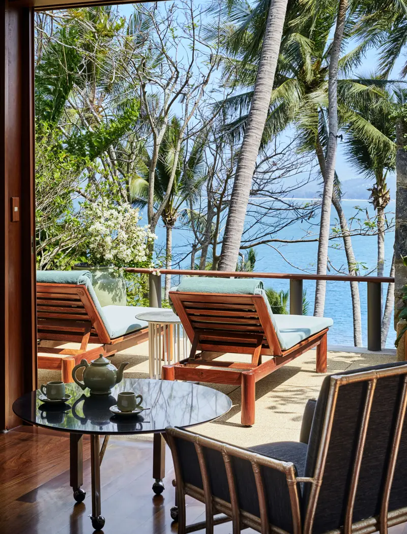 A villa terrace with armchairs looking out to sea