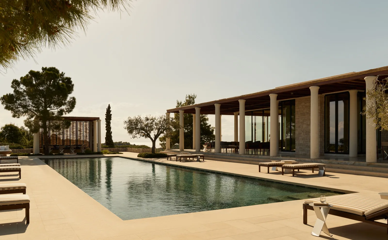 A 6-bedroom villa’s 24-metre pool, before the colonnaded portico and a pavilion with a pergola.